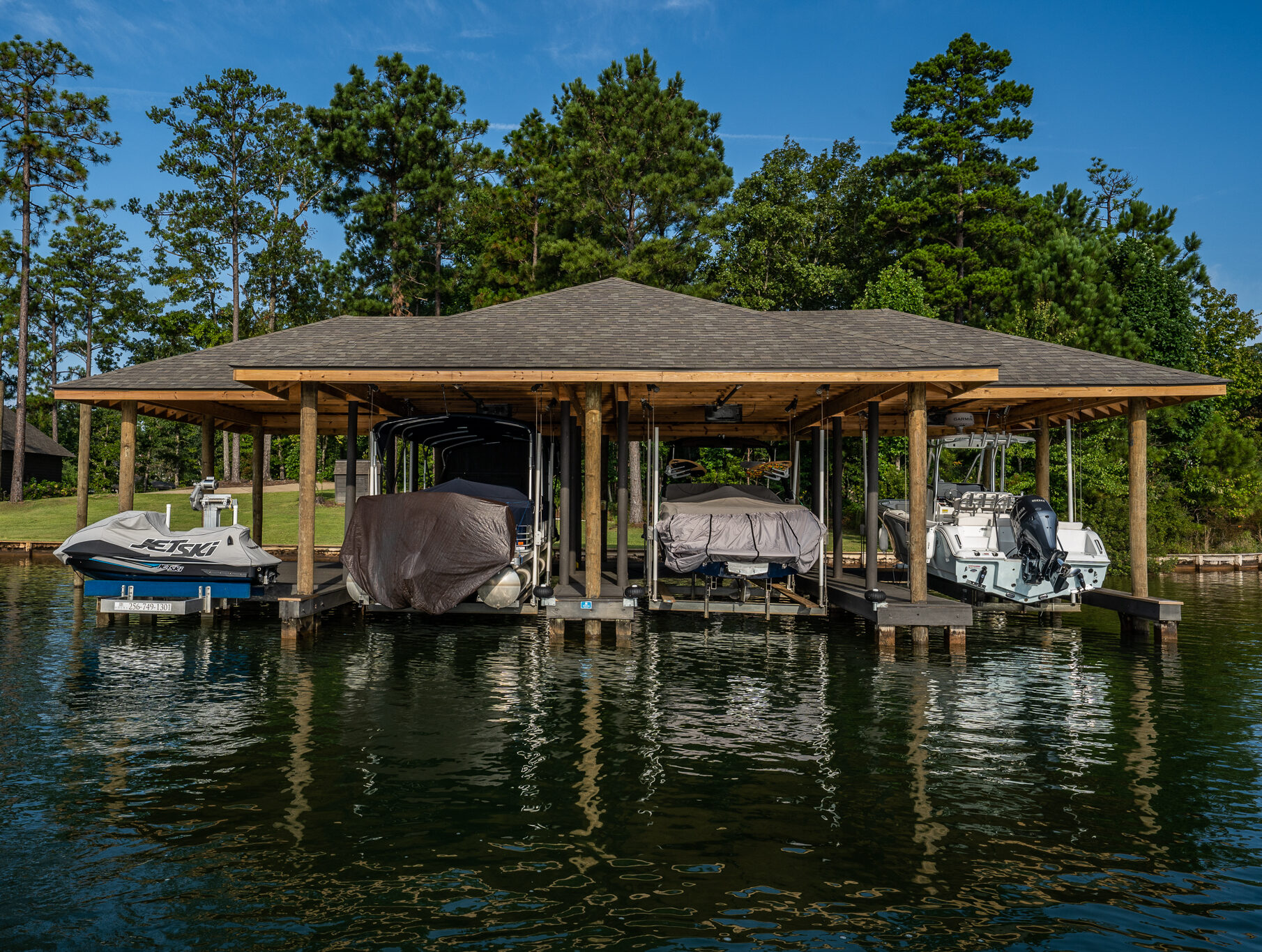 Single story boathouse with 3 boat lifts and 1 pwc lift